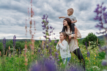 Mother and children in flowery meadow
