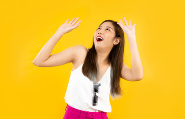 young asian woman reaction like something falling on her head isolated over yellow background,...