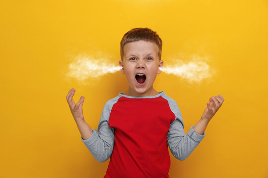 Aggressive little boy with steam coming out of his ears on orange background