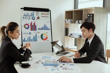 Businessman and woman hands working with finance marketing chart and Business teamwork and working on digital laptop computer with advisor showing plan of investment to clients at table office.
