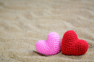 Summer style with Red and Pink Heart Knitting on a sea sand. background for add text. Backdrop love...