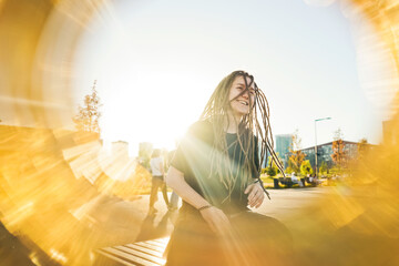 Portrait of young happy woman with dreadlocks