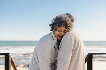 Fototapeta na wymiar Happy senior woman laughing while leaning on her husband