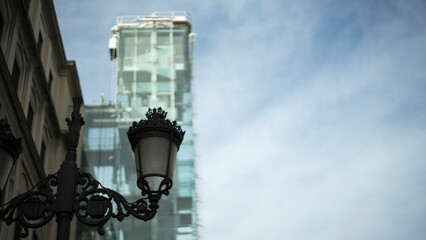 Fototapeta na wymiar Black Street lantern on the background of modern building, Madrid 