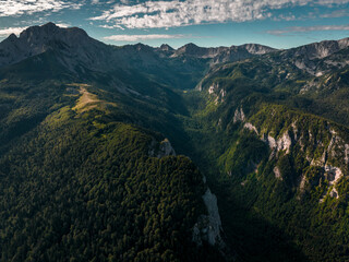 Maglic Mountain on the border of Bosnia and Herzegovina and Montenegro with canyon, Aerial Shot with golden sunlight valley (wide) - Sutjeska - obrazy, fototapety, plakaty