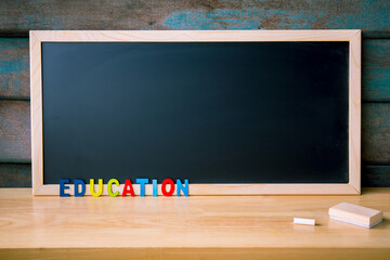 Magnet chalk blackboard with Wood Alphabet letters on the table. Copy space for design or add text...