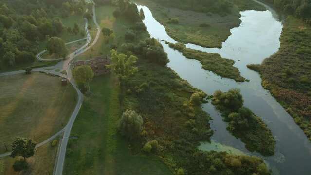 Winding river in the city park. City park at dawn. Aerial photography