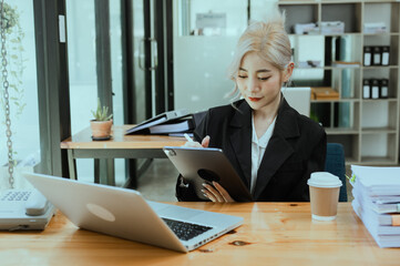 Friendly cheerful asian businesswoman smiling, people emotions and casual concept, positive woman working in office workspace.