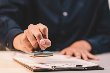 Businessman making agreement at office. it's a contract paper. Human hand holding pen mystery document on the table. It's a big decisions for business corporate.