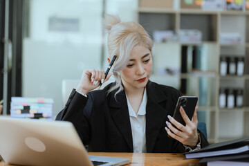 Businesswoman working with calculator and laptop computer at office workplace, finance marketing chart, Business digital technology and marketing concept.