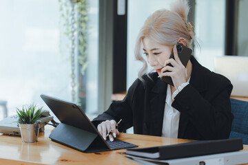 Businesswoman working with calculator and laptop computer at office workplace, finance marketing chart, Business digital technology and marketing concept.