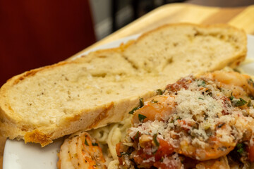 Shrimp Fra Diavolo Topped with Shaved Asiago Cheese served with  a slice of Asiago Cheese Bread 