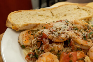 Shrimp Fra Diavolo Topped with Shaved Asiago Cheese served with  a slice of Asiago Cheese Bread 