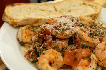 Shrimp Fra Diavolo Topped with Shaved Asiago Cheese served with  a slice of Asiago Cheese Bread 