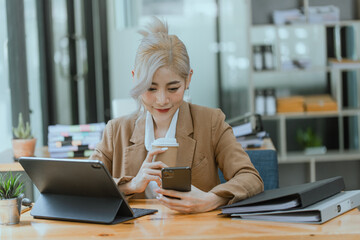 Businesswoman working with calculator and laptop computer at office workplace, finance marketing chart, Business digital technology and marketing concept.