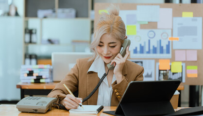 Businesswoman working with calculator and laptop computer at office workplace, finance marketing chart, Business digital technology and marketing concept.