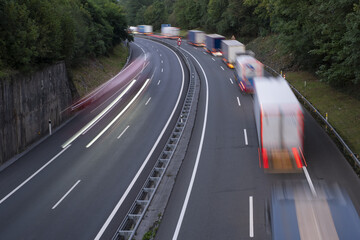 stack of trucks in a long traffic jam on the freeway at night