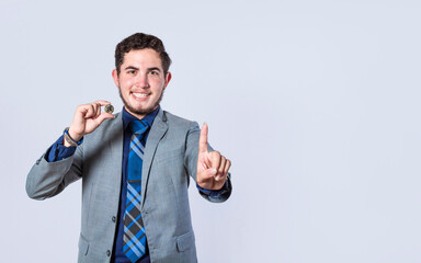 Businessman holding a bitcoin coin isolated. Smiling businessman holding a bitcoin pointing, Attractive Business Person holding a bitcoin and pointing. Cryptocurrency and investment concept