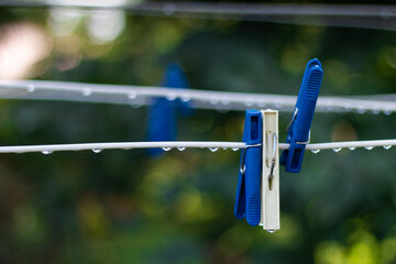 clothespins hang on a wire	