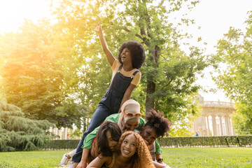 Happy young women best friends having fun together outdoors - Multiracial group bonding on top of...