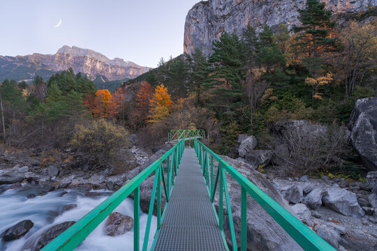 Metal bridge over river in mountains