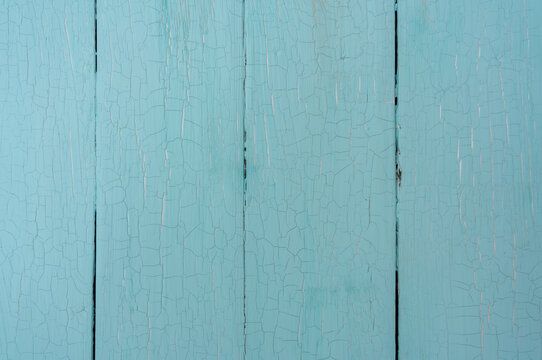 Image of the real background of the craquelure texture on old vertical boards of blue color