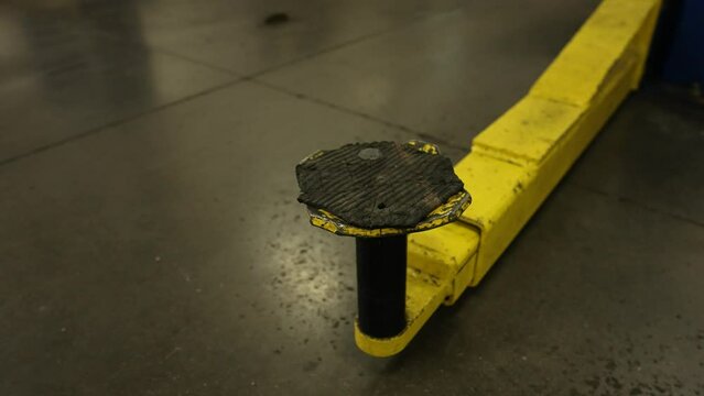 Jack stand post for mechanic car lift. Repair shop garage lift hoist for repair technician. Shot on 4k SONY A7SIII