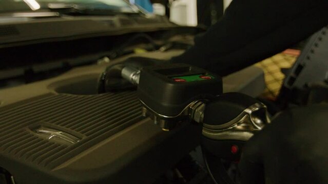 Filling engine with motor oil, push-in shot. Car mechanic repair service center garage. Shot on 4k SONY A7SIII