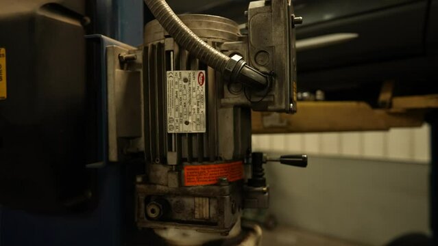 Car jack lift elevation mechanism, panning shot. Service center mechanic repairman car garage for sedans, SUVs and trucks. Shot on 4k SONY A7SIII.