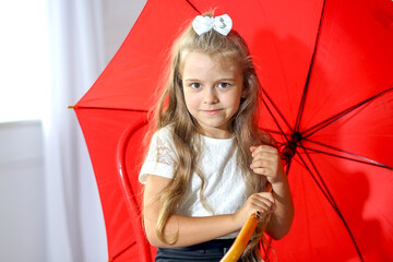 .Close portrait of a cute girl with a red umbrella. Autumn concept