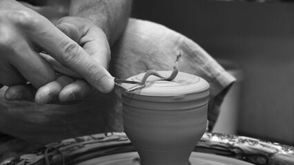 Art Therapy. Adult Man Making a Pot of Clay on a Potter's Wheel. Close-up Black and White. Monochrome