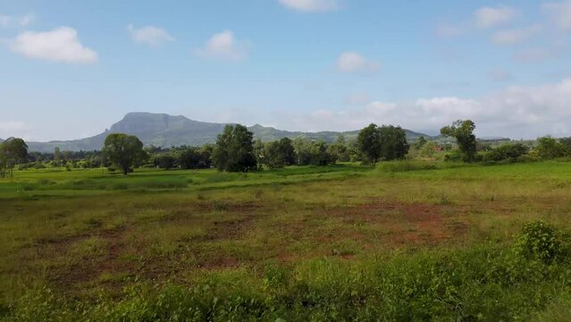 Stunning Scenery Of Trimbakeshwar Range And Lush Field In Western Ghats of Maharashtra In India. drone sideways
