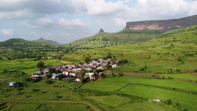 Idyllic Town Surrounded With Greenery Landscape Near Brahmagiri Mountain Range In The Western Ghats of Maharashtra, India. Aerial Drone Shot