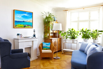 Custom-made home decoration concept: colorful living room with a framed print of a seascape photo and a throw pillow of the same picture.