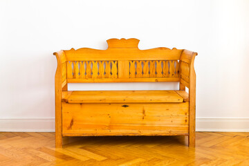 Restored antique wooden box bench with storage space unter the seat, circa 1880, against the white...