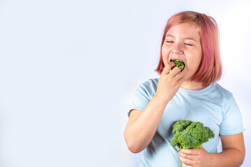 Cute kid  girl eats broccoli