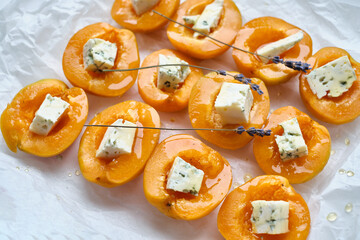 Apricots or peaches baked with blue cheese and lavender sprigs. Delicious dessert with fruits and...