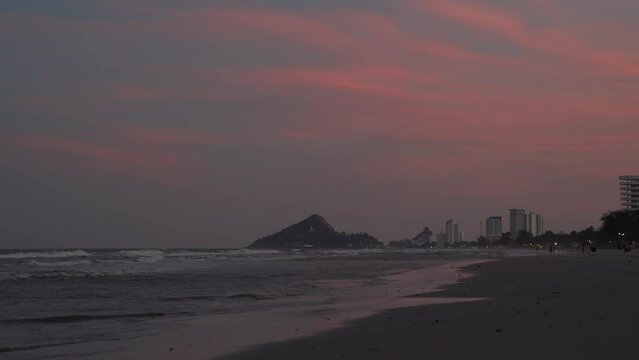 Dark Twilight time on the Beach with a little wave on it and The Pink Gray Sky tone.