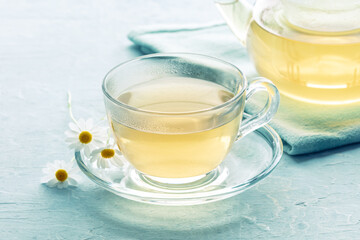 Chamomile tea. Camomile infusion in a cup with a tea pot, natural remedy