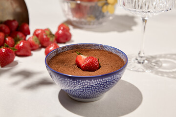 Classic italian dessert tiramisu on light background. Coffee dessert in ceramic bowl - homemade tiramisu. Desserts menu in trendy style. Aesthetic composition with tiramisu in cup.