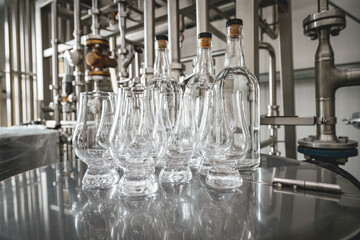 Modern distillery equipment. Industrial equipment for whisky production.  Set of glasses for whisky...