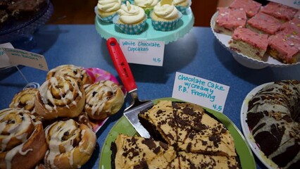 Slow slider shot of a variety desserts and baked goods displayed for sale