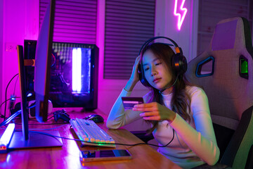 Top up online game with credit card concept. Gamer and E-Sport online of Asian woman playing online...