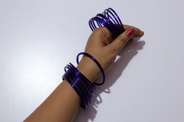 Woman's  Blue Colour many bangles on her wrist Isolated white background