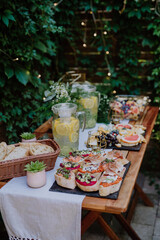 Dessert buffet at small wedding reception outside in the backyard.
