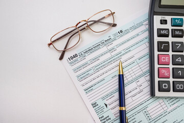 form 1040 with pen bitcoin coins calculator financial document.