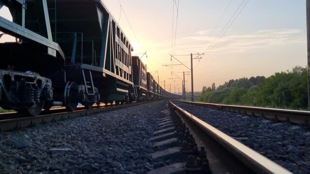 Freight train transports goods at sunset. Logistics, delivery of goods