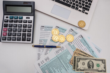 form 1040 with pen bitcoin coins calculator financial document.
