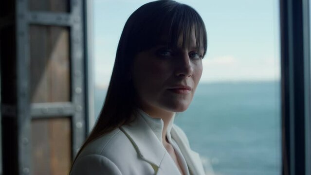 Sea panoramic window businesswoman portrait closeup. Manager posing ocean view