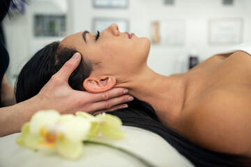 masseur doing therapeutic acupressure massage neck her female client in spa centre